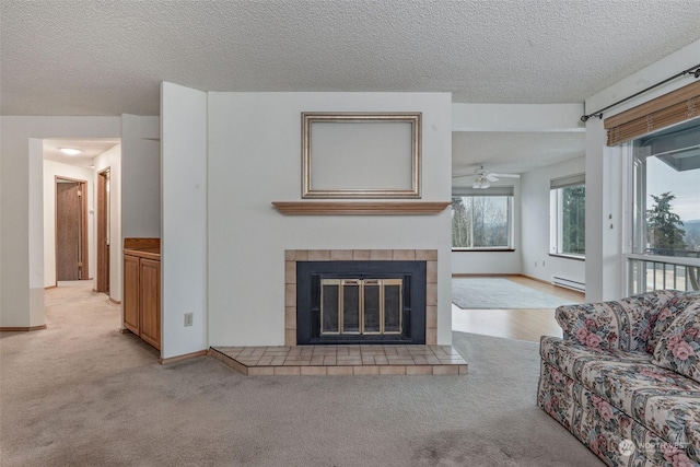 living room with a baseboard radiator, light carpet, a textured ceiling, and a fireplace