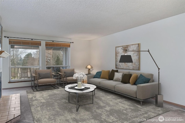 living room featuring carpet flooring, a textured ceiling, and baseboards