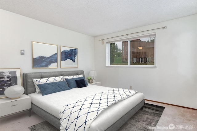 bedroom with baseboards, carpet, and a textured ceiling