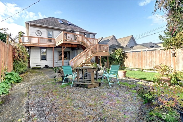 rear view of house with a wooden deck