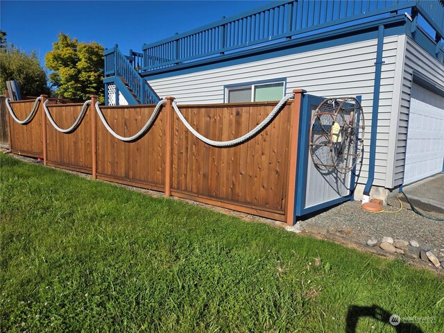 exterior space with a garage and a lawn