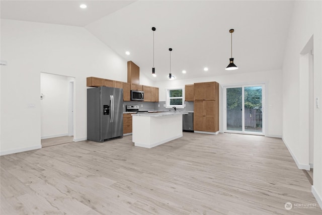 kitchen with a center island, high vaulted ceiling, sink, hanging light fixtures, and stainless steel appliances