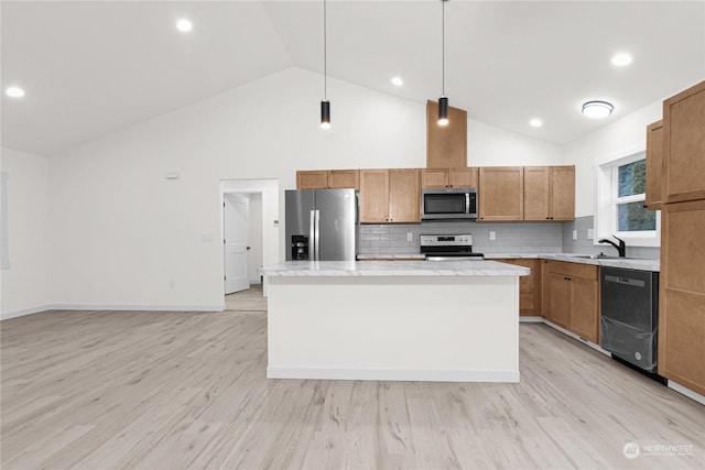 kitchen with a center island, stainless steel appliances, light hardwood / wood-style flooring, pendant lighting, and decorative backsplash