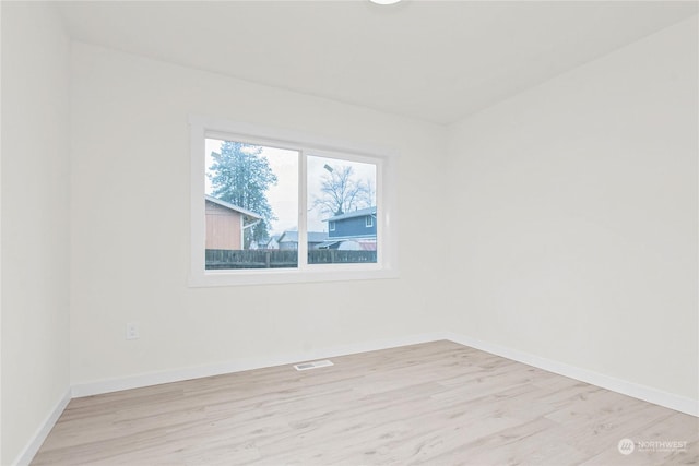 spare room featuring light hardwood / wood-style flooring