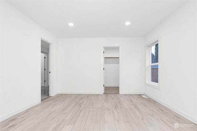 empty room with light hardwood / wood-style flooring