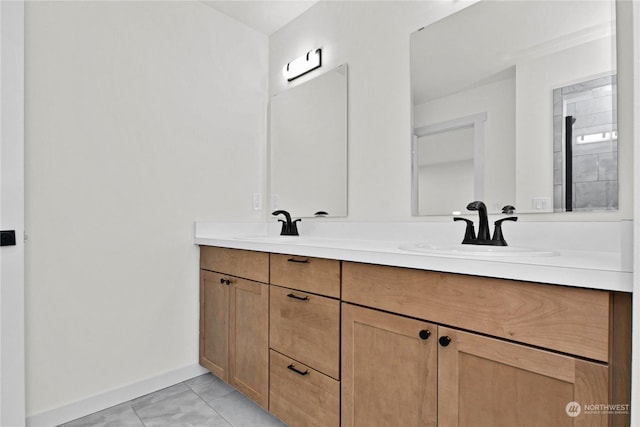 bathroom with tile patterned flooring and vanity