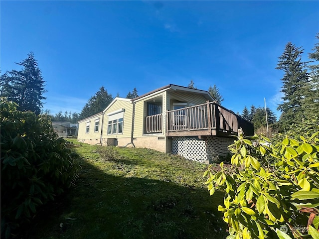 view of property exterior with a lawn