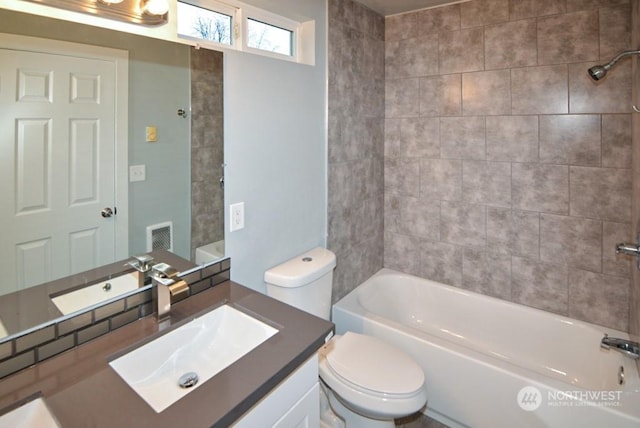 full bathroom featuring vanity, toilet, and tiled shower / bath combo