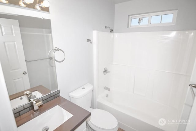 full bathroom featuring shower / bathing tub combination, vanity, and toilet