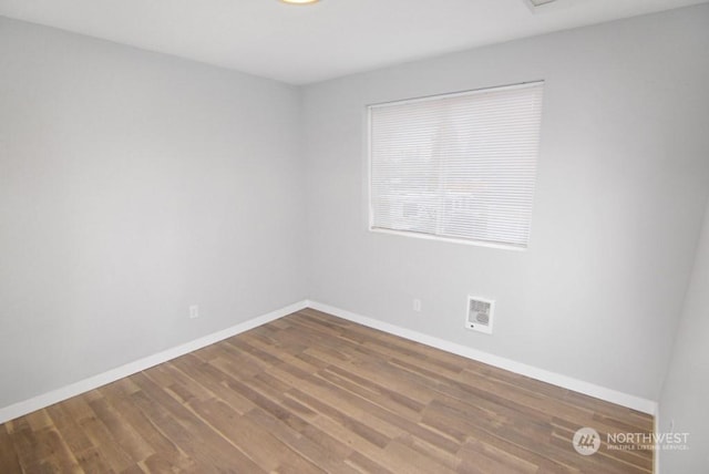 empty room featuring hardwood / wood-style flooring