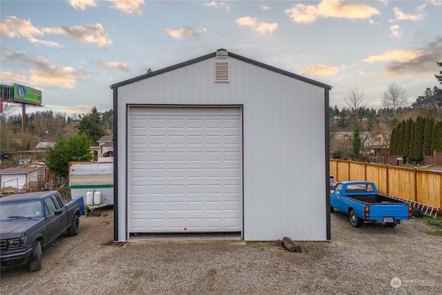 view of garage at dusk