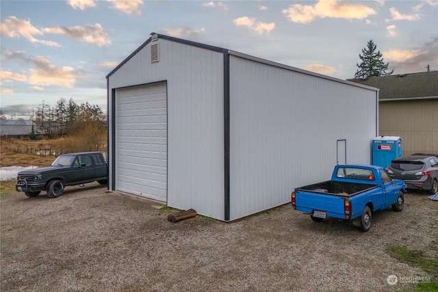 outdoor structure at dusk featuring a garage