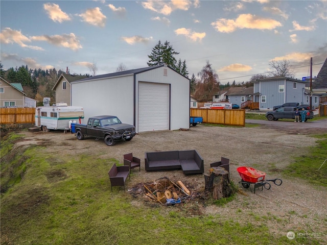 view of garage at dusk