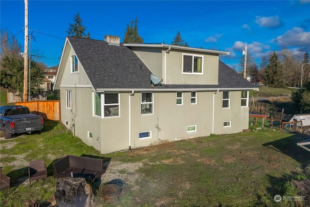 rear view of house featuring a lawn