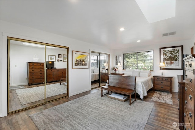 bedroom with a closet and dark wood-type flooring