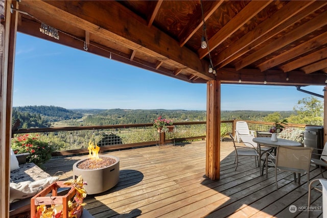 wooden terrace with a fire pit