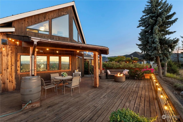 deck at dusk with a fire pit