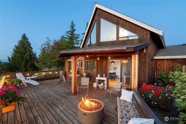 wooden deck with an outdoor fire pit