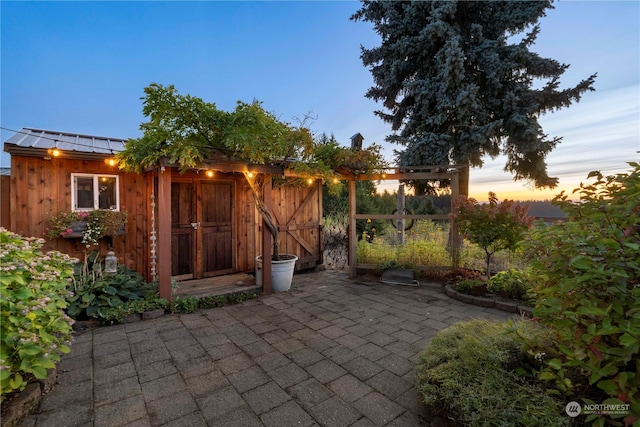 view of patio terrace at dusk