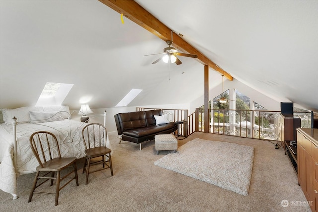 carpeted bedroom with lofted ceiling with skylight and ceiling fan