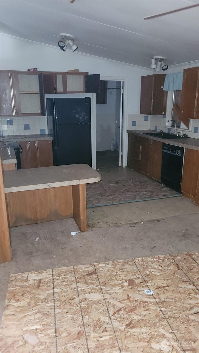 kitchen featuring sink, vaulted ceiling, and black appliances