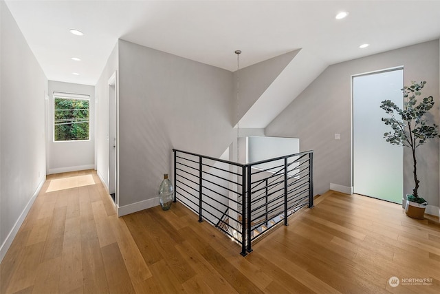 stairway with hardwood / wood-style floors