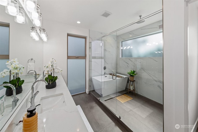 bathroom with vanity and independent shower and bath