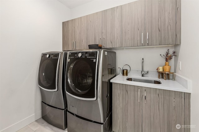 laundry area with washer and dryer, light tile patterned flooring, cabinets, and sink