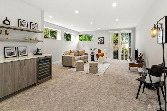 living room featuring bar area, light colored carpet, and beverage cooler