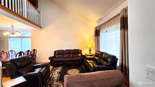 living room featuring a notable chandelier and vaulted ceiling