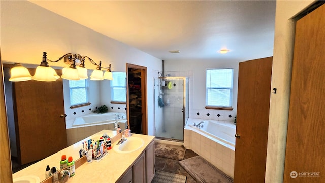 bathroom with shower with separate bathtub, vanity, tile patterned floors, and a notable chandelier