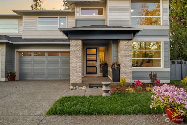 exterior entry at dusk with a garage