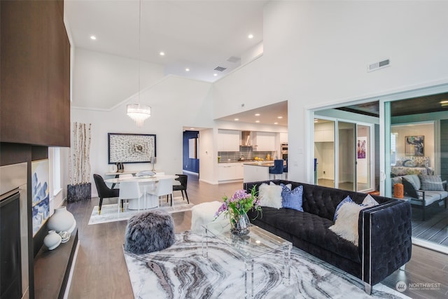 living room featuring dark hardwood / wood-style floors and high vaulted ceiling