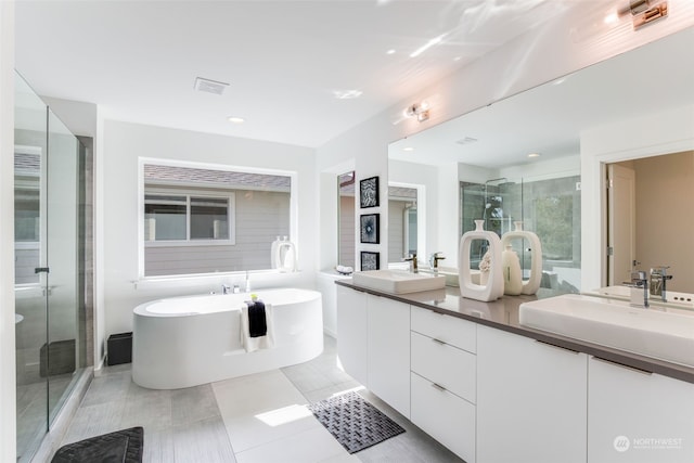 bathroom with separate shower and tub, tile patterned flooring, and vanity