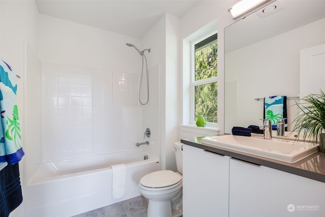 full bathroom featuring vanity, bathing tub / shower combination, and toilet