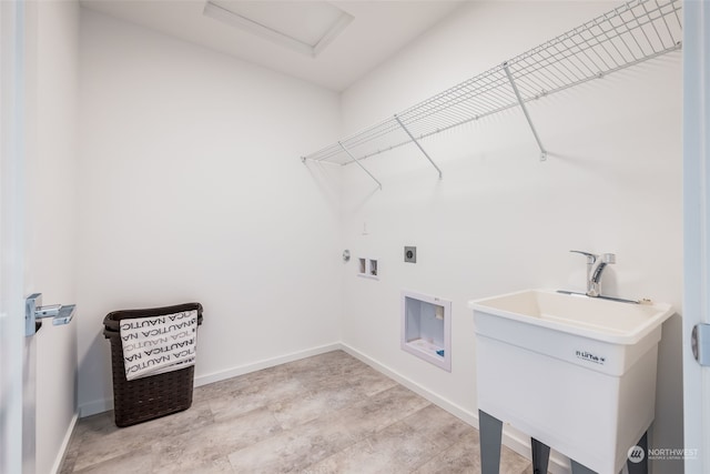 clothes washing area with hookup for an electric dryer, washer hookup, gas dryer hookup, and sink