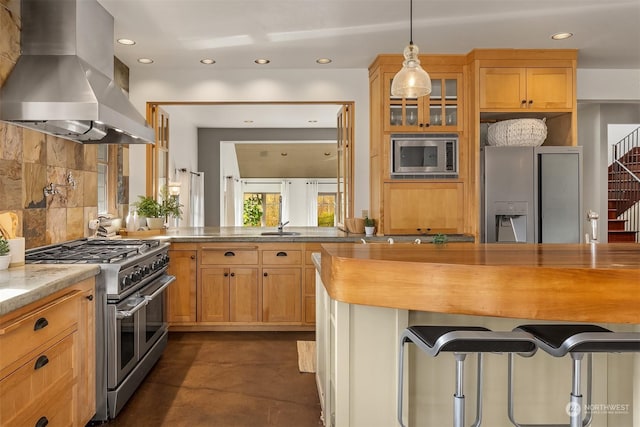 kitchen with decorative backsplash, light stone counters, ventilation hood, stainless steel appliances, and decorative light fixtures