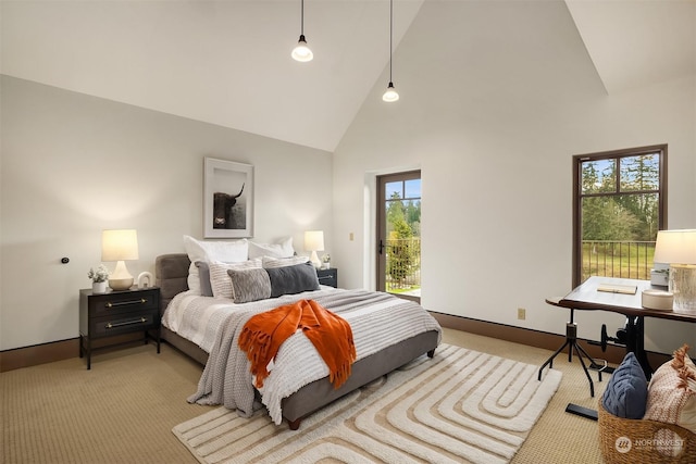 carpeted bedroom featuring high vaulted ceiling