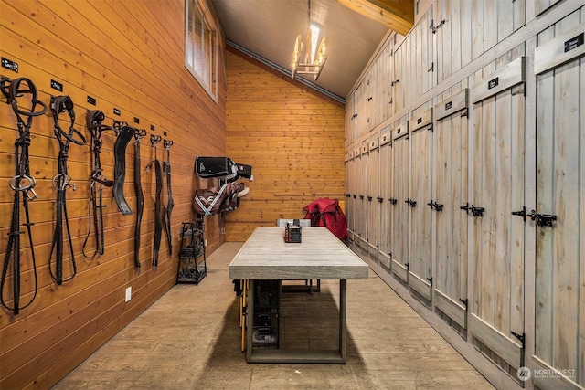 interior space featuring wooden walls, vaulted ceiling, and a notable chandelier