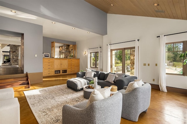 living room featuring concrete flooring, a healthy amount of sunlight, high vaulted ceiling, and wooden ceiling