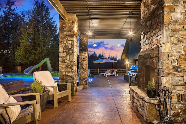 view of patio terrace at dusk