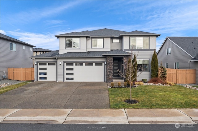 prairie-style home featuring a garage and a front yard