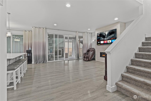 interior space with hardwood / wood-style floors and a large fireplace