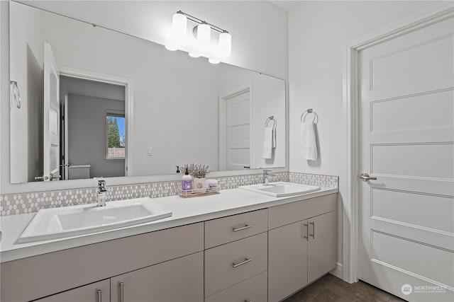 bathroom with tasteful backsplash and vanity