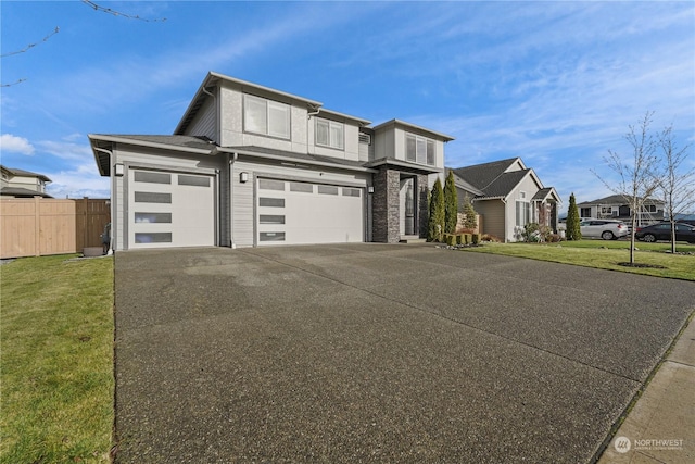 view of front of home featuring a front lawn and a garage