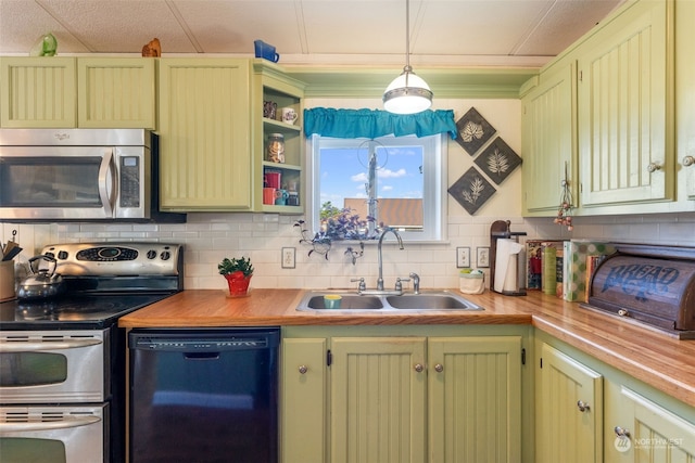 kitchen with butcher block countertops, appliances with stainless steel finishes, backsplash, hanging light fixtures, and sink