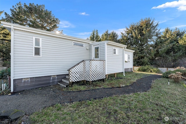 back of house with a lawn