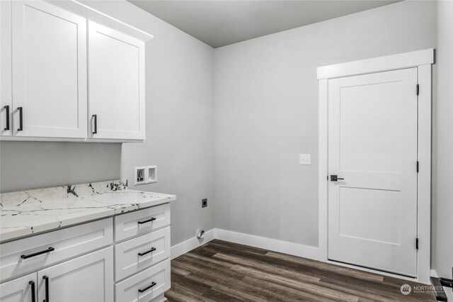 washroom with hookup for an electric dryer, dark hardwood / wood-style flooring, cabinets, and washer hookup