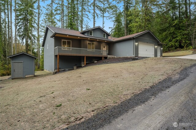 view of front facade with a garage and a storage unit