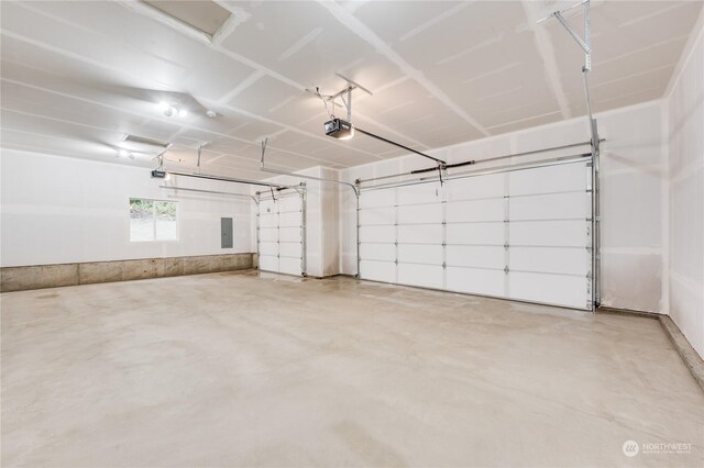 garage with electric panel and a garage door opener